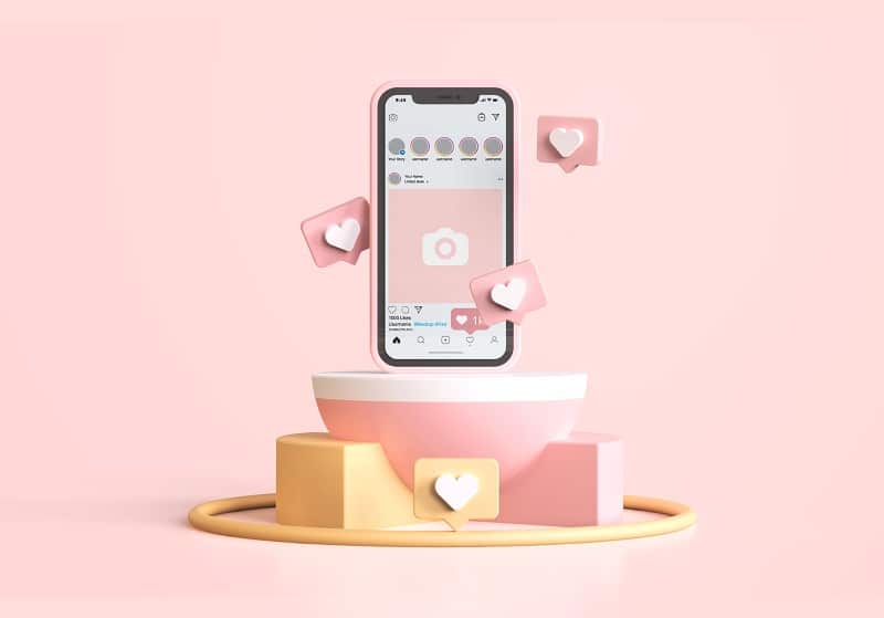 Téléphone avec une page Instagram ouverte sur fond rose