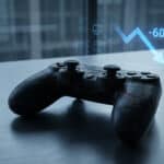 A cracked video game controller on a metallic surface, with a holographic -60% sales drop graph and faint legal documents in the background.