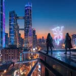 Two figures on a futuristic rooftop overlook a vibrant, neon-lit cityscape at twilight, facing a floating blue-purple supernatural symbol.