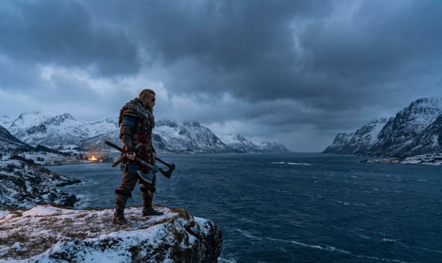 Photorealistic image of a Viking warrior in armor on a snowy cliff, holding axes, overlooking an icy fjord and mountains at dusk.