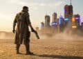 A lone figure with a cybernetic arm and energy weapon stands in a cracked desert, facing a dystopian city at dusk.